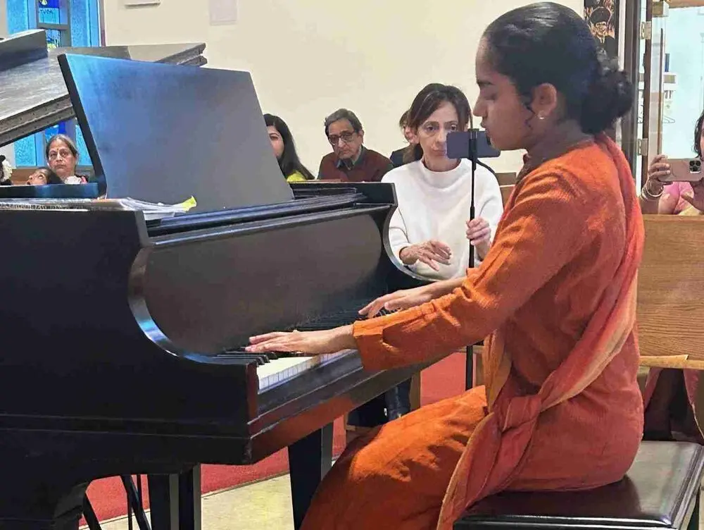 Piano Solo Performance in Traditional Orange Dress – Diwali Concert